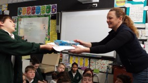 Dr Kate receives copies of "Jimmy Four-Nicks the Burrunan Dolphin" from Lakes Entrance Primary School students